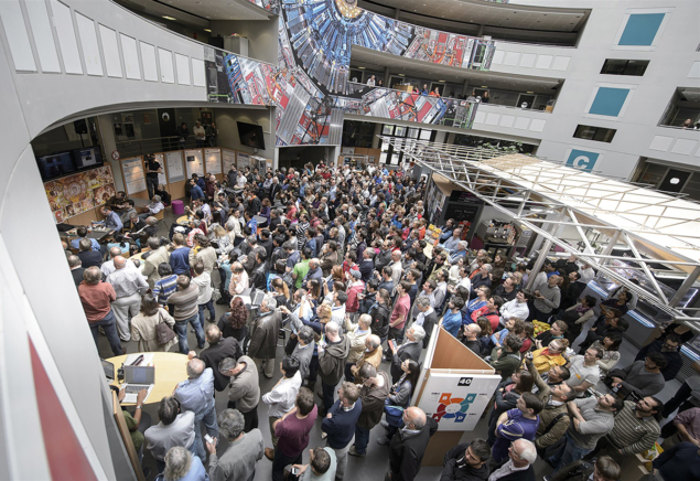 ATLAS and CMS physicists in Building 40 on 8 October 2013